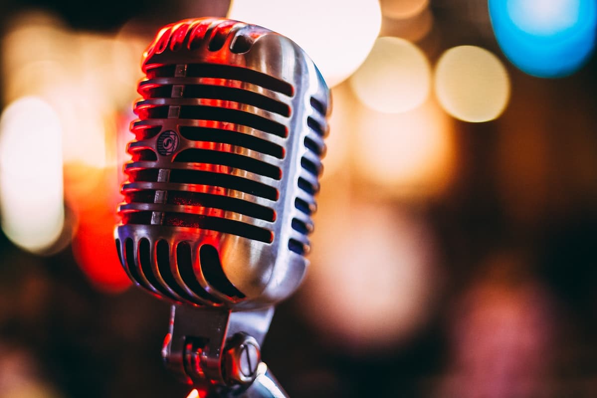 A vintage microphone lit by warm studio lights